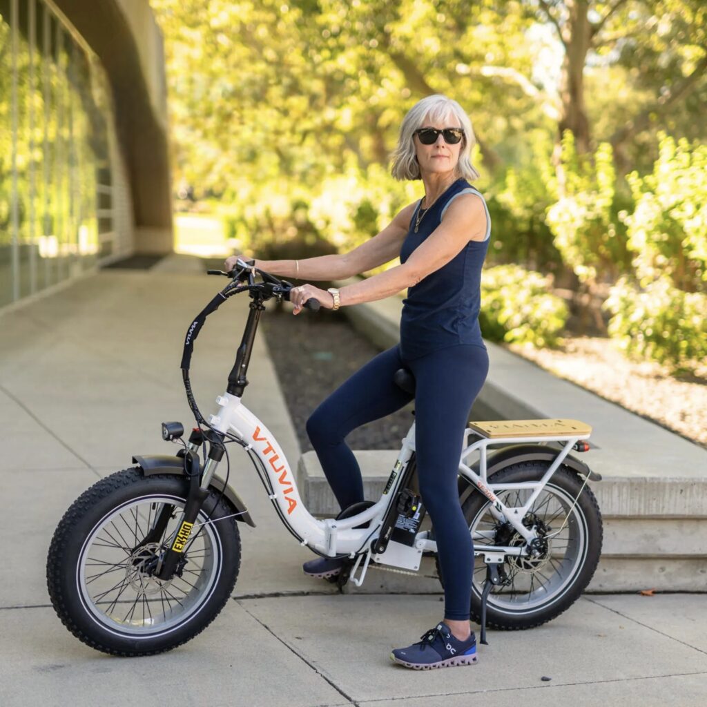 Retired female on a vtuvia e-bike riding in a retirement community