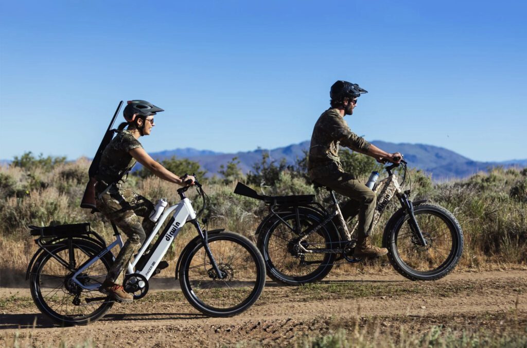 Dirwin Pioneer fat tire electric bike on a muddy hunting trail, used for silent backcountry access.