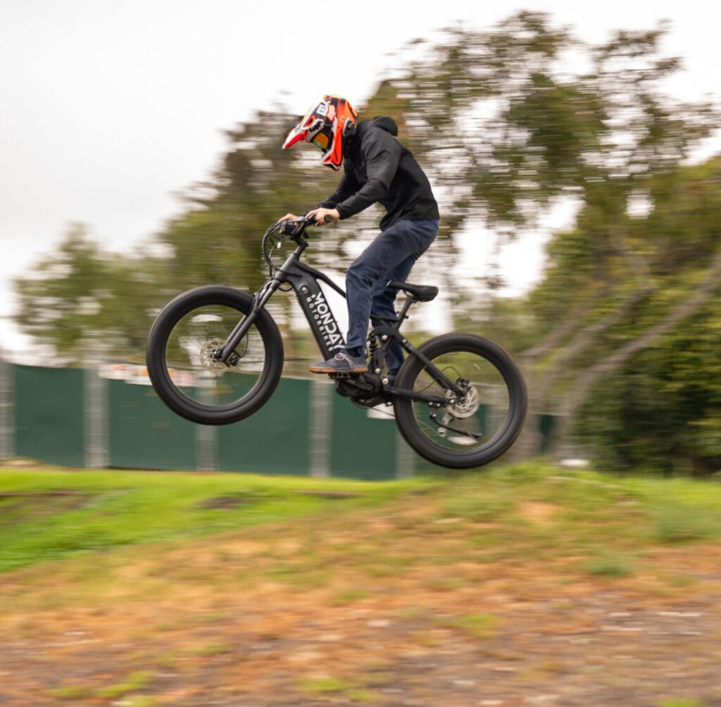 Monday Motorbikes Antero Stealth jumping on off-road mountain bike track